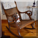 F83. Caned rocking chair.